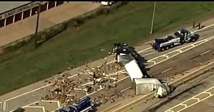 Big truck overturned on the highway, people fell from the car.

