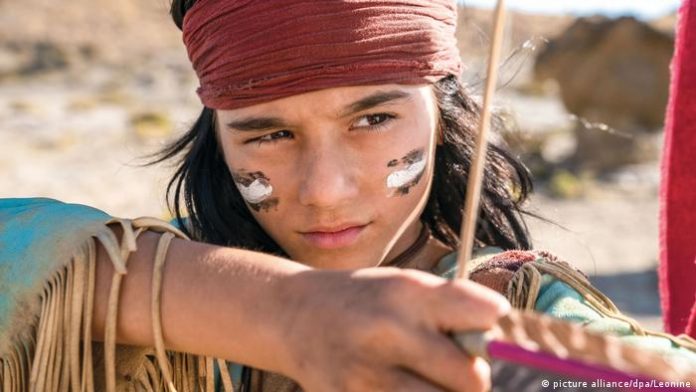 Mika Ullritz as Winnetou draws a bow.
